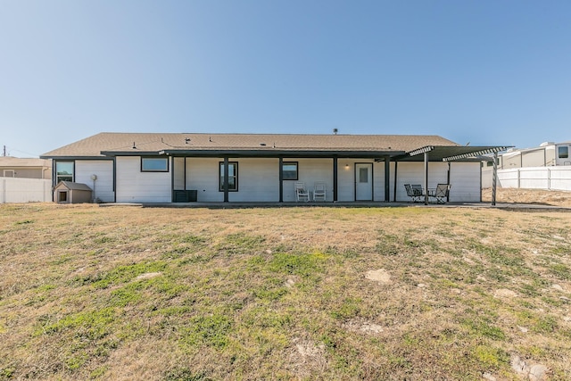 back of house with cooling unit, a yard, and a patio area