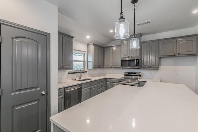 kitchen with appliances with stainless steel finishes, light countertops, visible vents, and gray cabinetry