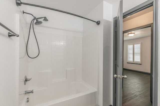 full bath featuring shower / bath combination and wood finished floors