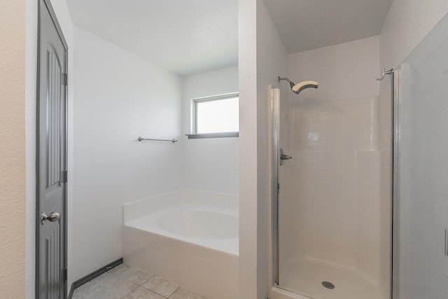 full bath with tile patterned flooring, a garden tub, and a shower stall