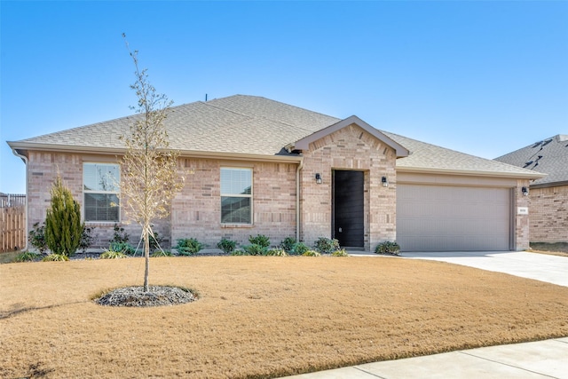 view of front of house with a garage and a front yard