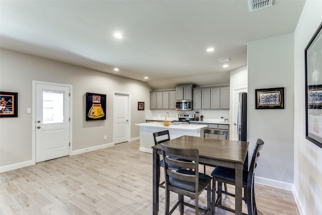 dining area with sink and light hardwood / wood-style flooring