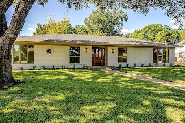 ranch-style home featuring a front yard