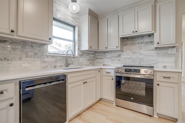 kitchen featuring sink, stainless steel electric range, light wood-type flooring, dishwasher, and decorative backsplash