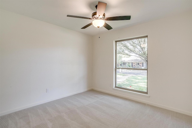 spare room featuring ceiling fan and light colored carpet