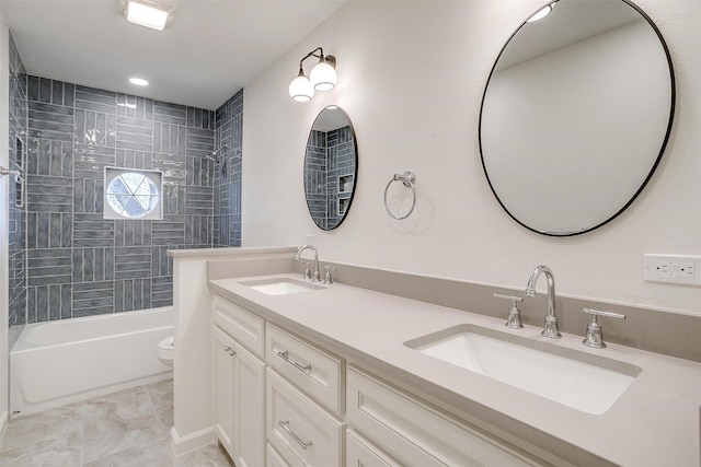 full bathroom with vanity, tiled shower / bath combo, and toilet