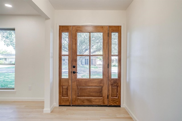 foyer entrance with light wood-type flooring