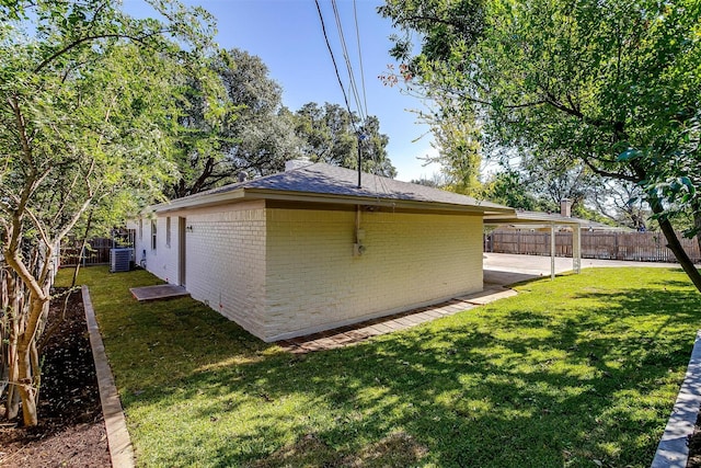 view of home's exterior featuring central AC, a yard, and a patio