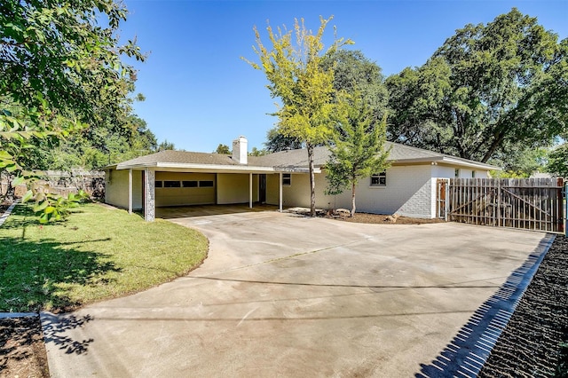 single story home featuring a garage and a front lawn