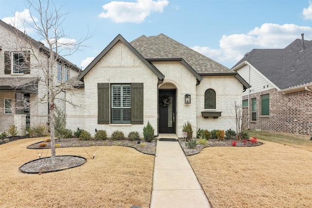 french country style house with a front yard