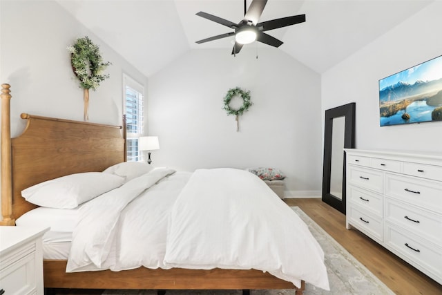 bedroom featuring vaulted ceiling, ceiling fan, and light hardwood / wood-style floors