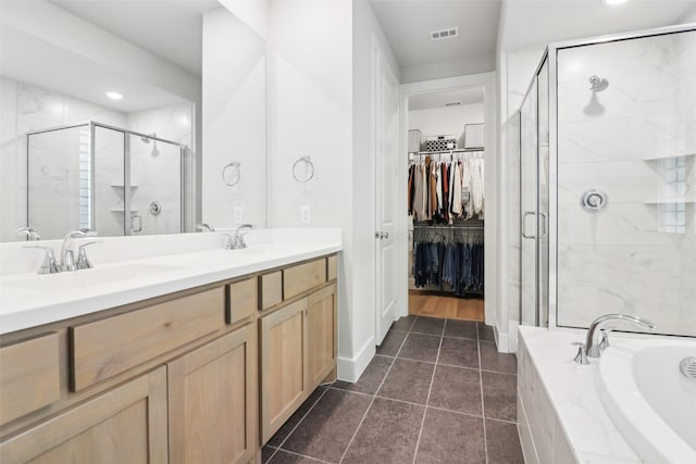 bathroom with tile patterned floors, vanity, and independent shower and bath