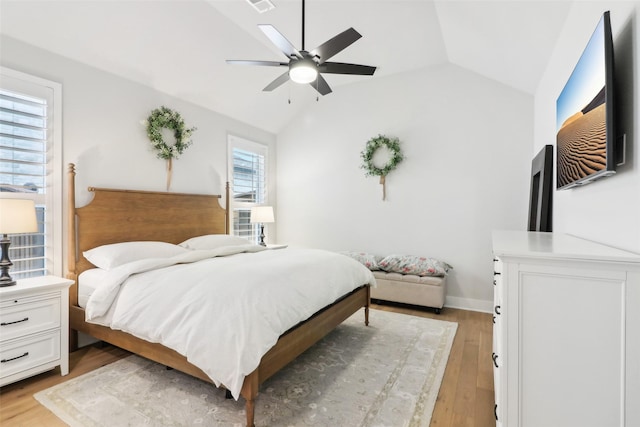 bedroom featuring ceiling fan, lofted ceiling, and light hardwood / wood-style floors