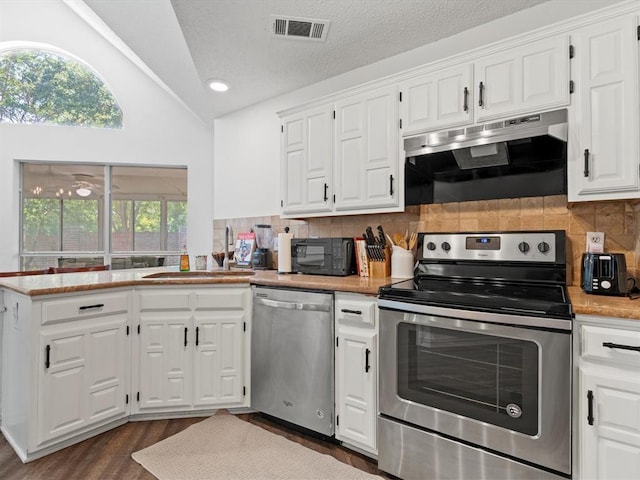 kitchen featuring stainless steel appliances and white cabinets