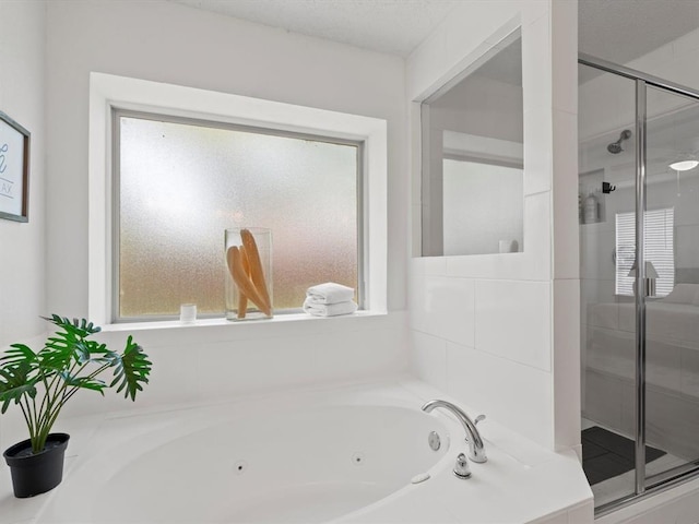 bathroom featuring separate shower and tub