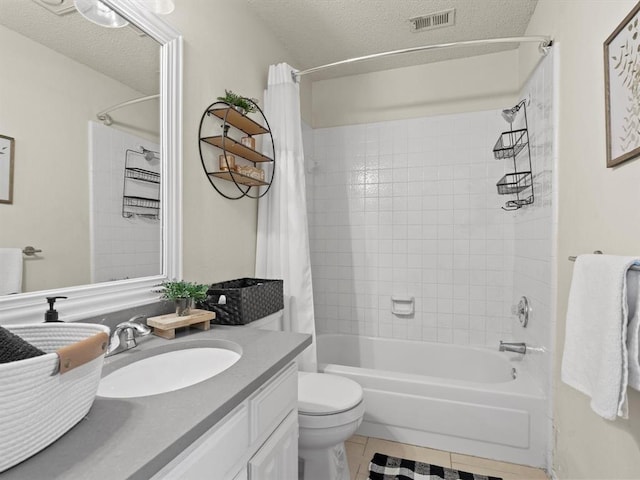 full bathroom featuring vanity, shower / tub combo, toilet, tile patterned floors, and a textured ceiling