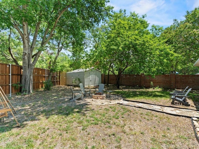 view of yard with a fire pit and a storage unit