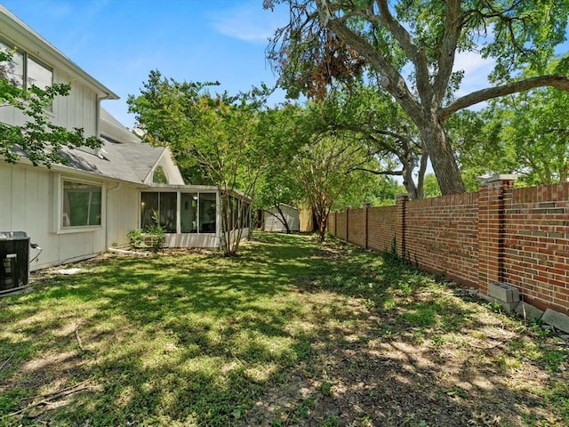 view of yard featuring a sunroom and cooling unit