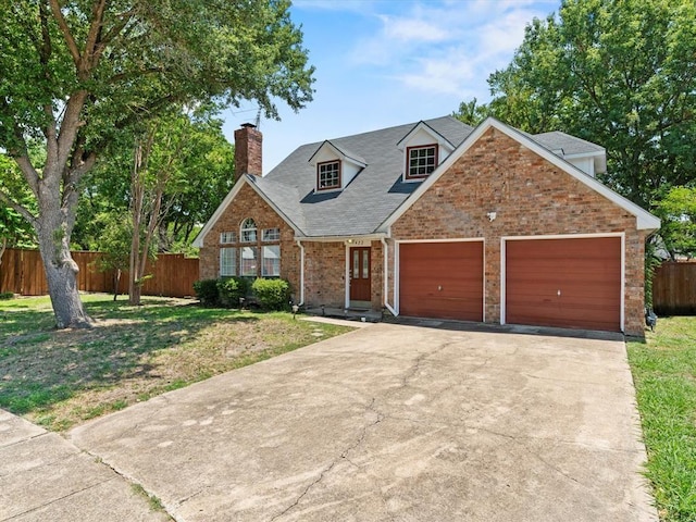 view of front of house featuring a garage and a front yard