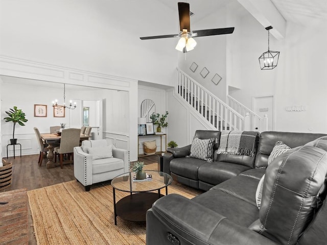 living room featuring beamed ceiling, wood-type flooring, ceiling fan with notable chandelier, and high vaulted ceiling