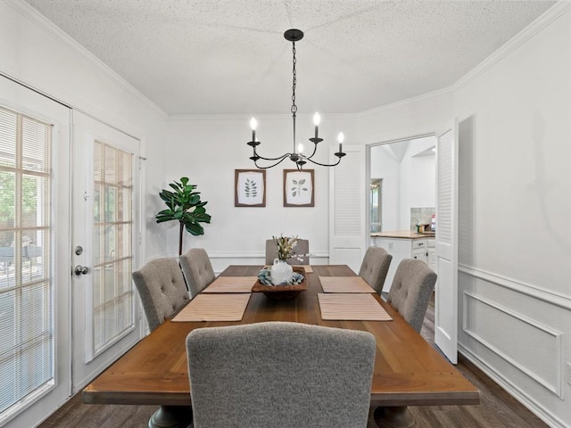 dining space featuring ornamental molding, dark hardwood / wood-style floors, and a textured ceiling