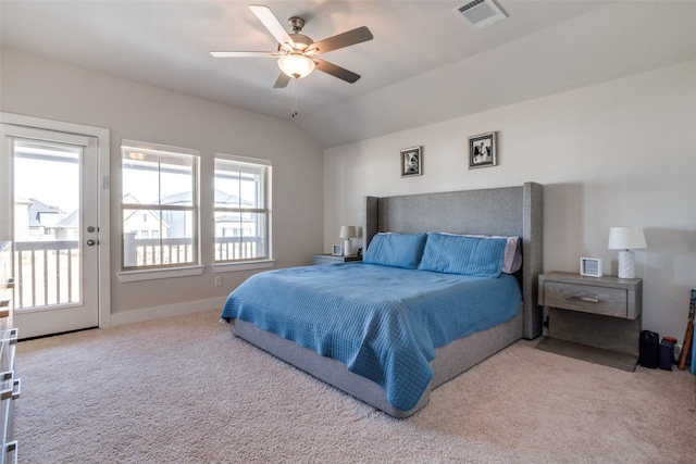 carpeted bedroom featuring multiple windows, access to outside, ceiling fan, and vaulted ceiling