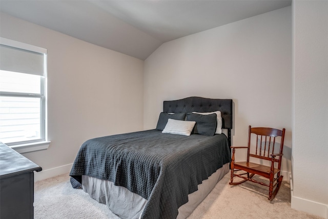 carpeted bedroom with vaulted ceiling