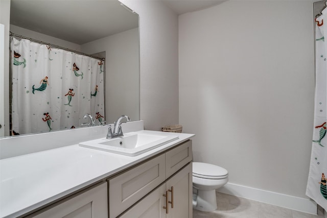 bathroom with vanity, tile patterned floors, and toilet