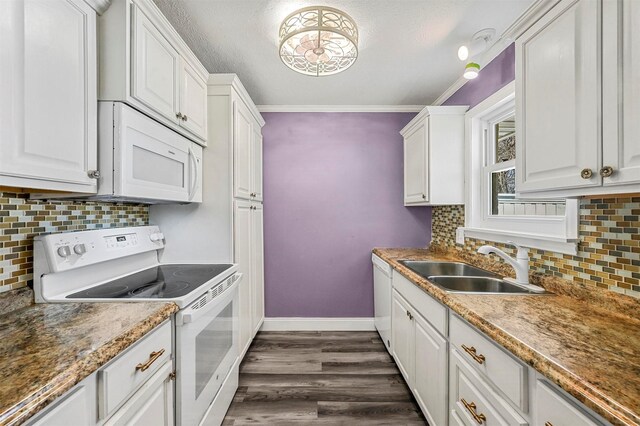 kitchen with white cabinetry, sink, white appliances, and dark hardwood / wood-style flooring