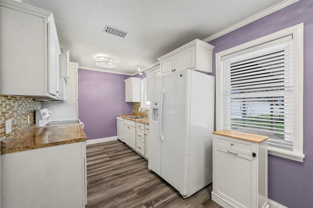 kitchen featuring white appliances, sink, decorative backsplash, and white cabinets