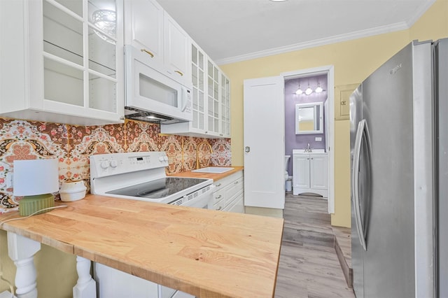 kitchen featuring white cabinetry, crown molding, white appliances, and kitchen peninsula