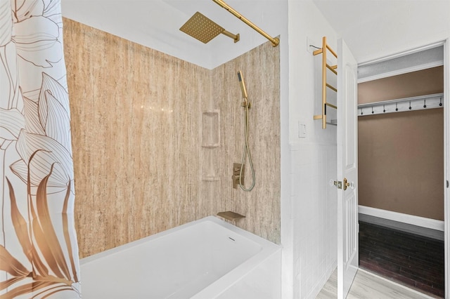 bathroom with hardwood / wood-style floors and shower / bathtub combination with curtain