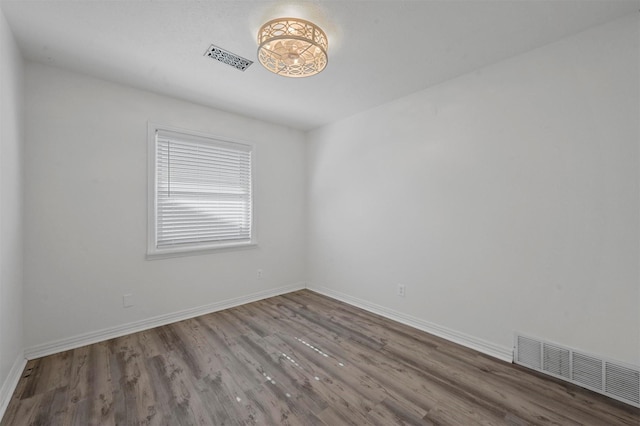 empty room with hardwood / wood-style flooring