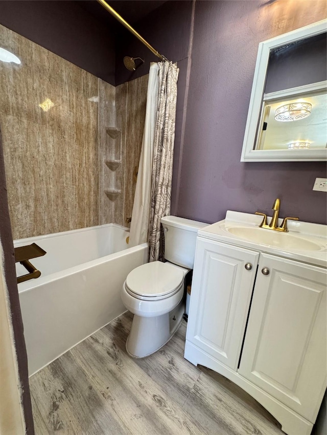 full bathroom featuring shower / tub combo with curtain, hardwood / wood-style floors, vanity, and toilet