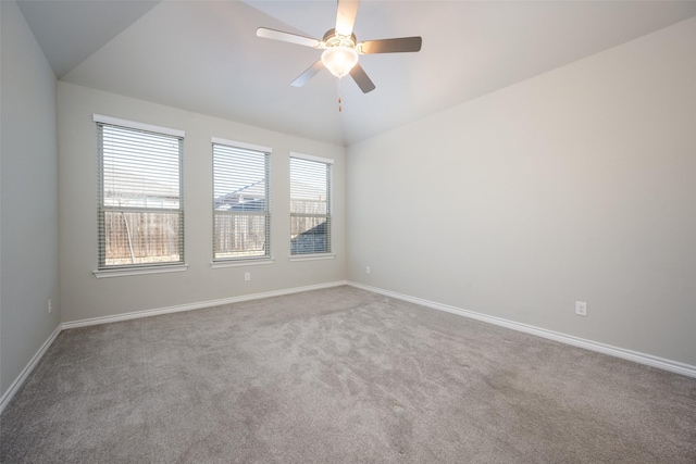 spare room with carpet floors, vaulted ceiling, and ceiling fan