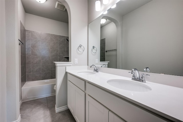 full bathroom with tile patterned flooring, vanity, toilet, and tiled shower / bath