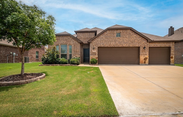 view of front facade featuring a garage, central AC unit, and a front lawn