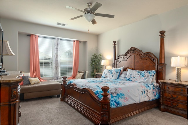 carpeted bedroom featuring visible vents and a ceiling fan