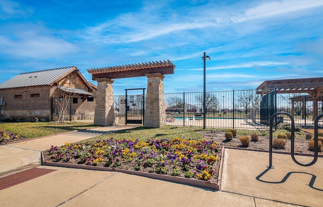 view of community with a swimming pool, a pergola, and fence