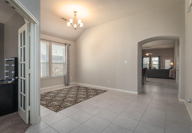 interior space with ceiling fan with notable chandelier and vaulted ceiling