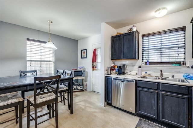 kitchen featuring plenty of natural light, dishwasher, sink, and hanging light fixtures