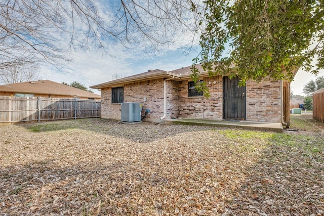 rear view of property featuring a patio and central air condition unit