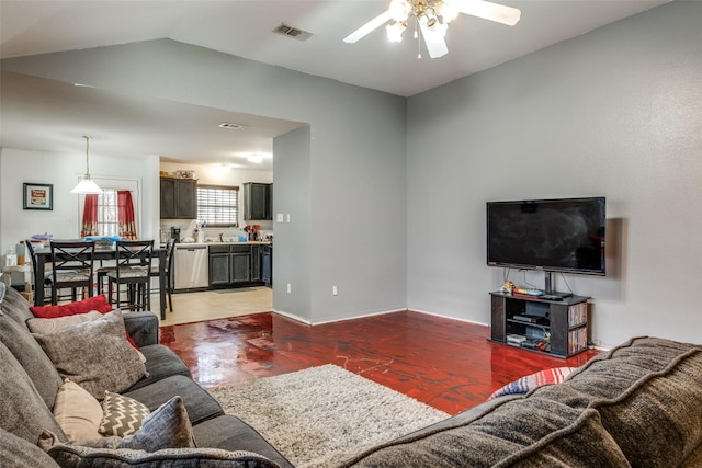 living room featuring ceiling fan and vaulted ceiling