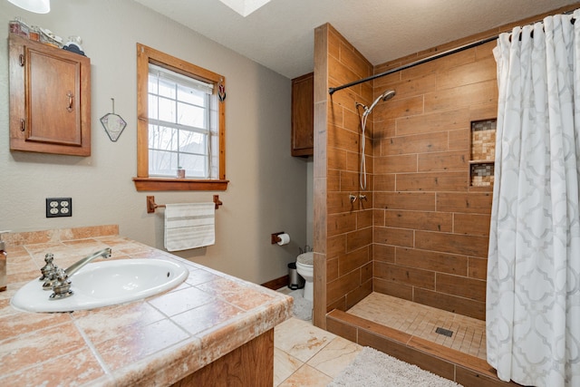 bathroom featuring vanity, toilet, and walk in shower