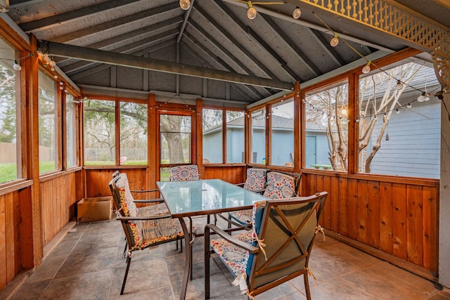 sunroom featuring lofted ceiling with beams