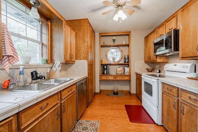 kitchen featuring tasteful backsplash, stainless steel appliances, and tile counters