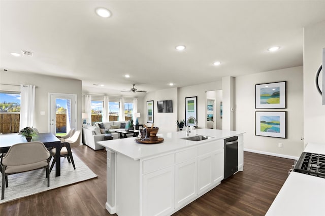 kitchen with dark hardwood / wood-style floors, white cabinetry, sink, a kitchen island with sink, and stainless steel dishwasher