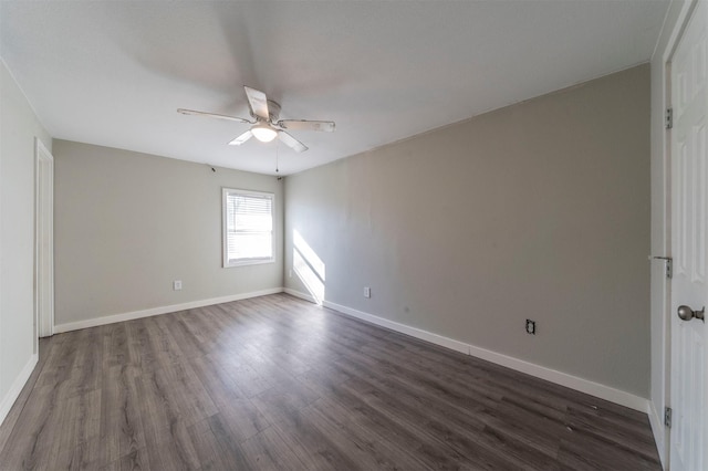 spare room featuring dark wood-type flooring and ceiling fan