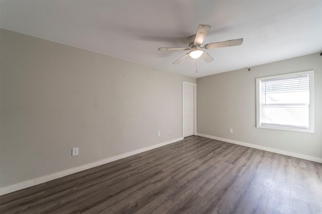 spare room featuring ceiling fan and dark hardwood / wood-style flooring