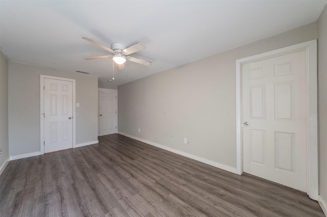 unfurnished bedroom with dark wood-type flooring and ceiling fan